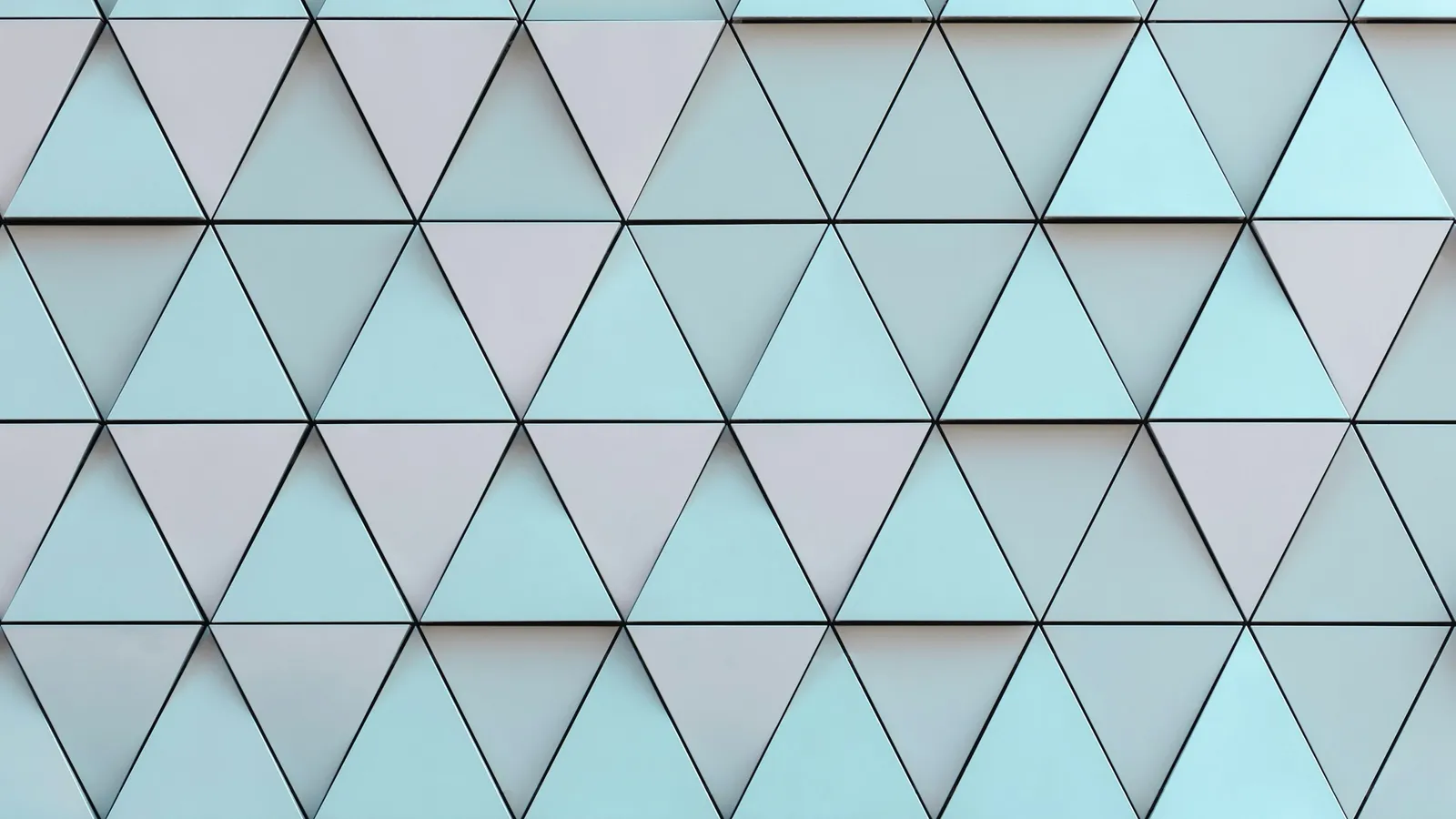 A wall of triangular tiles in pale blue