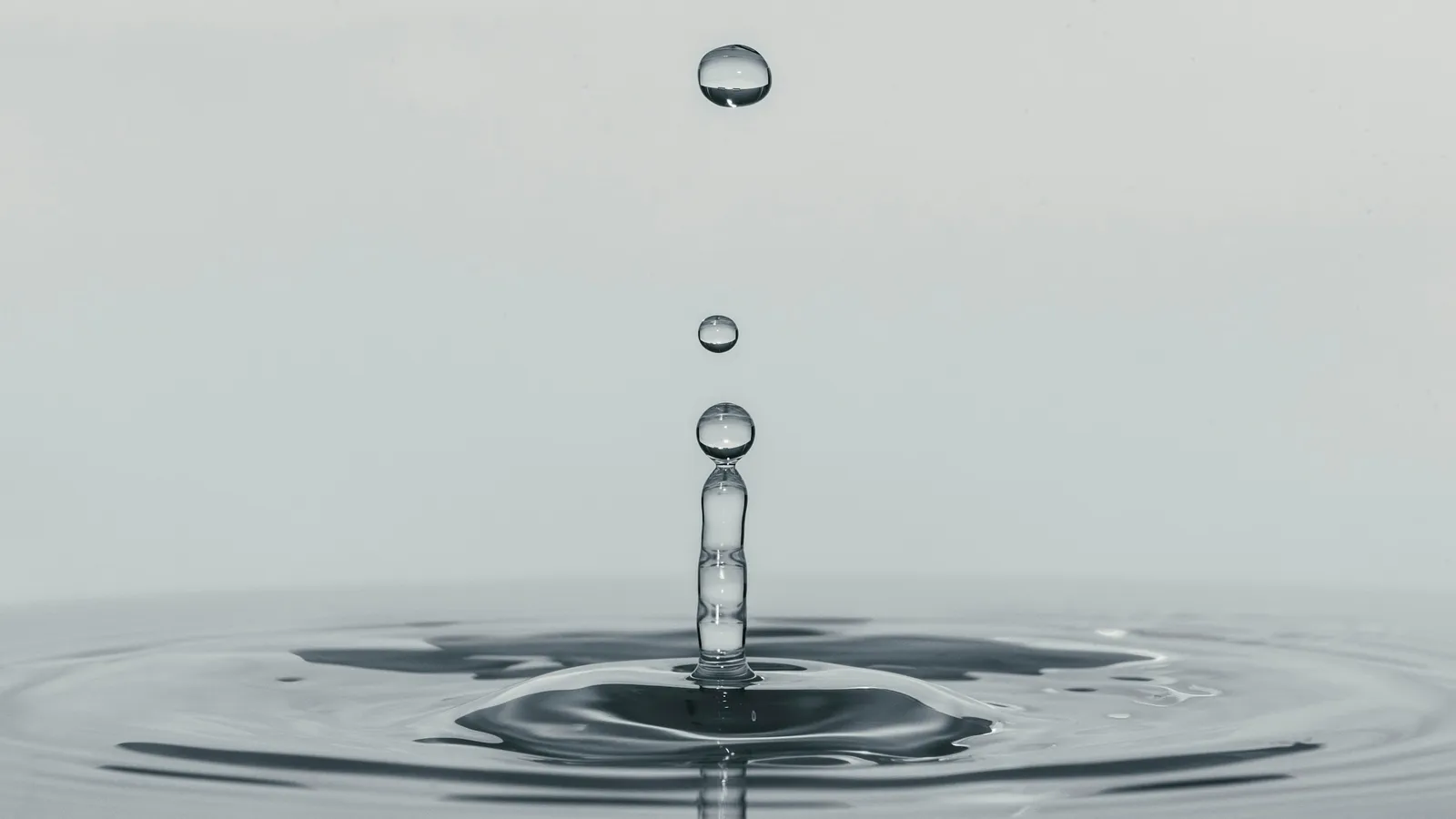 A water droplet splashing into a still surface