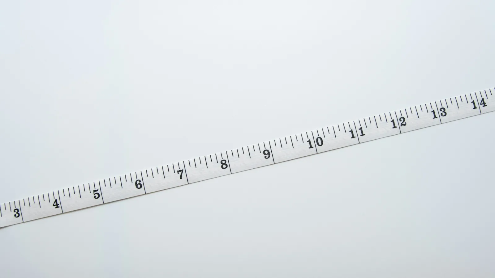 A white measuring tape on a white surface