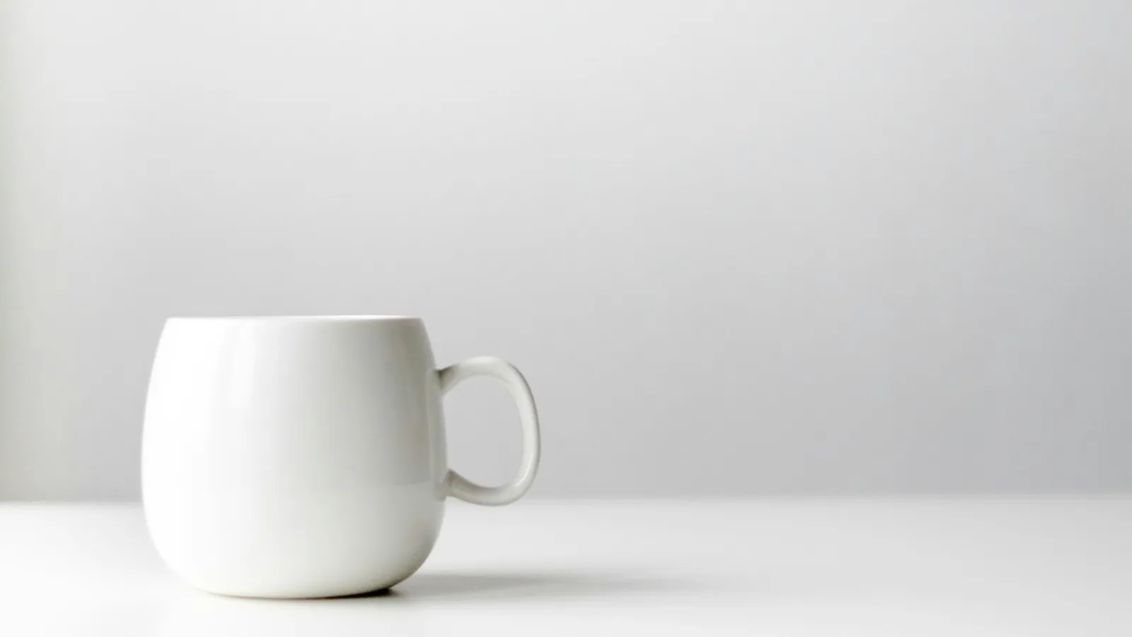 A white mug on a white table