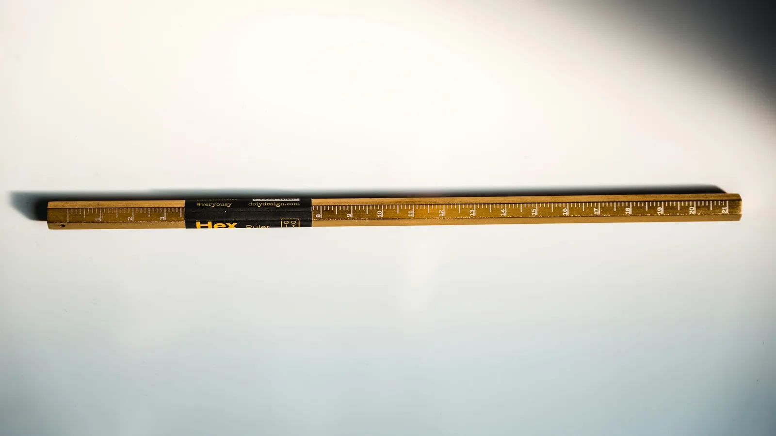 A wooden metre ruler on a white surface