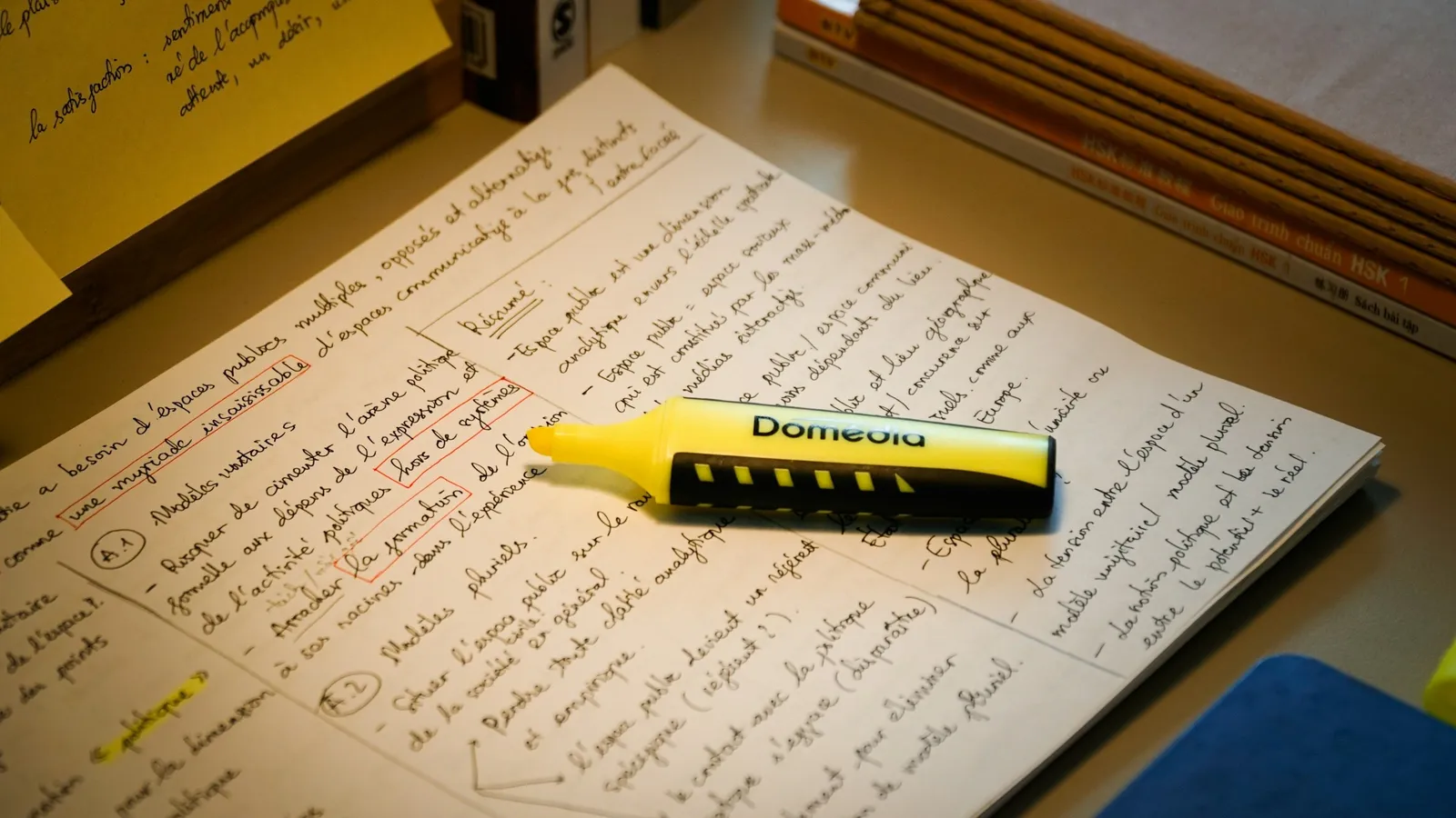 A yellow highlighter lying on printed pages of text