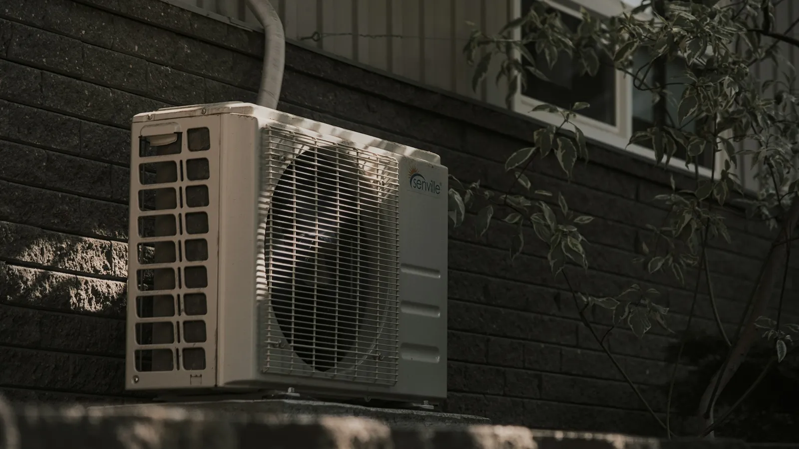 An air conditioner outdoor unit mounted on a wall