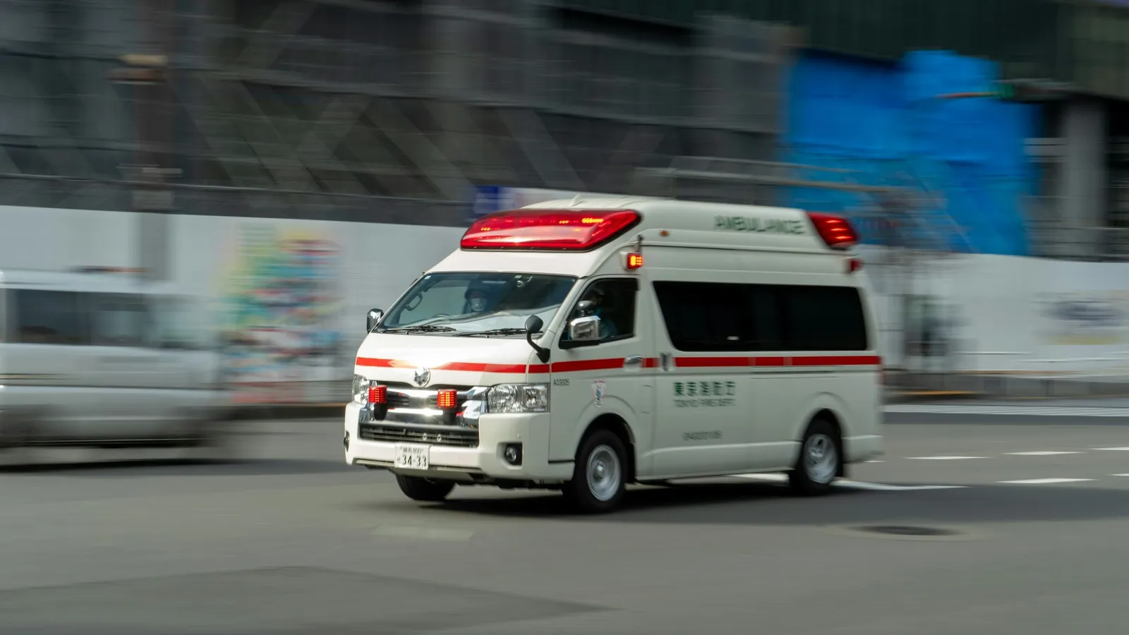 An ambulance speeding past with a motion-blurred background