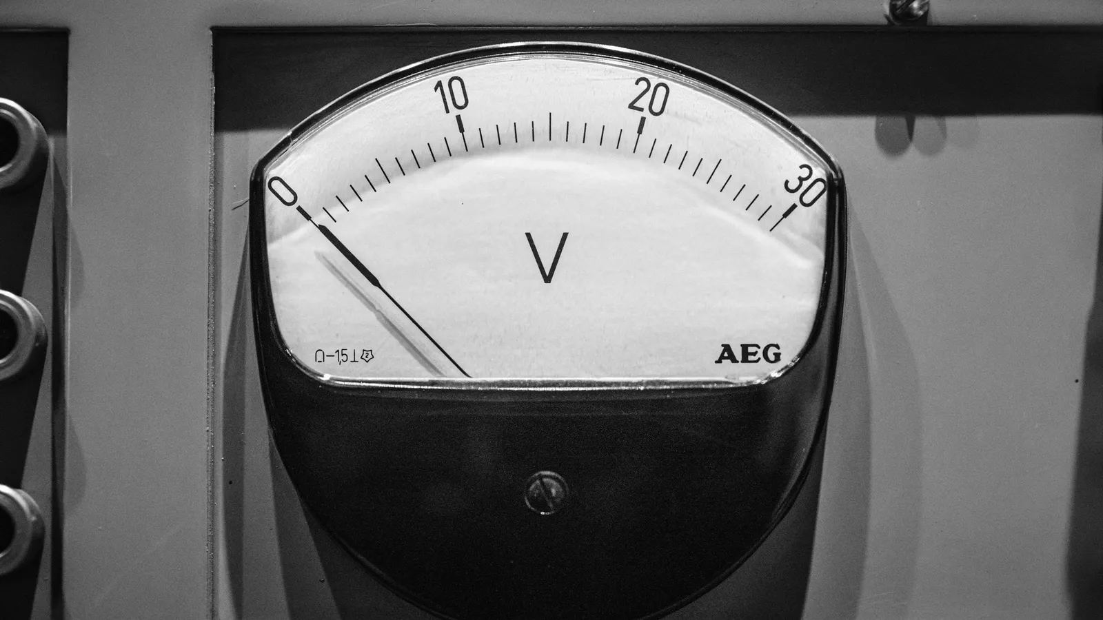 An analogue meter dial with a needle set into a grey panel