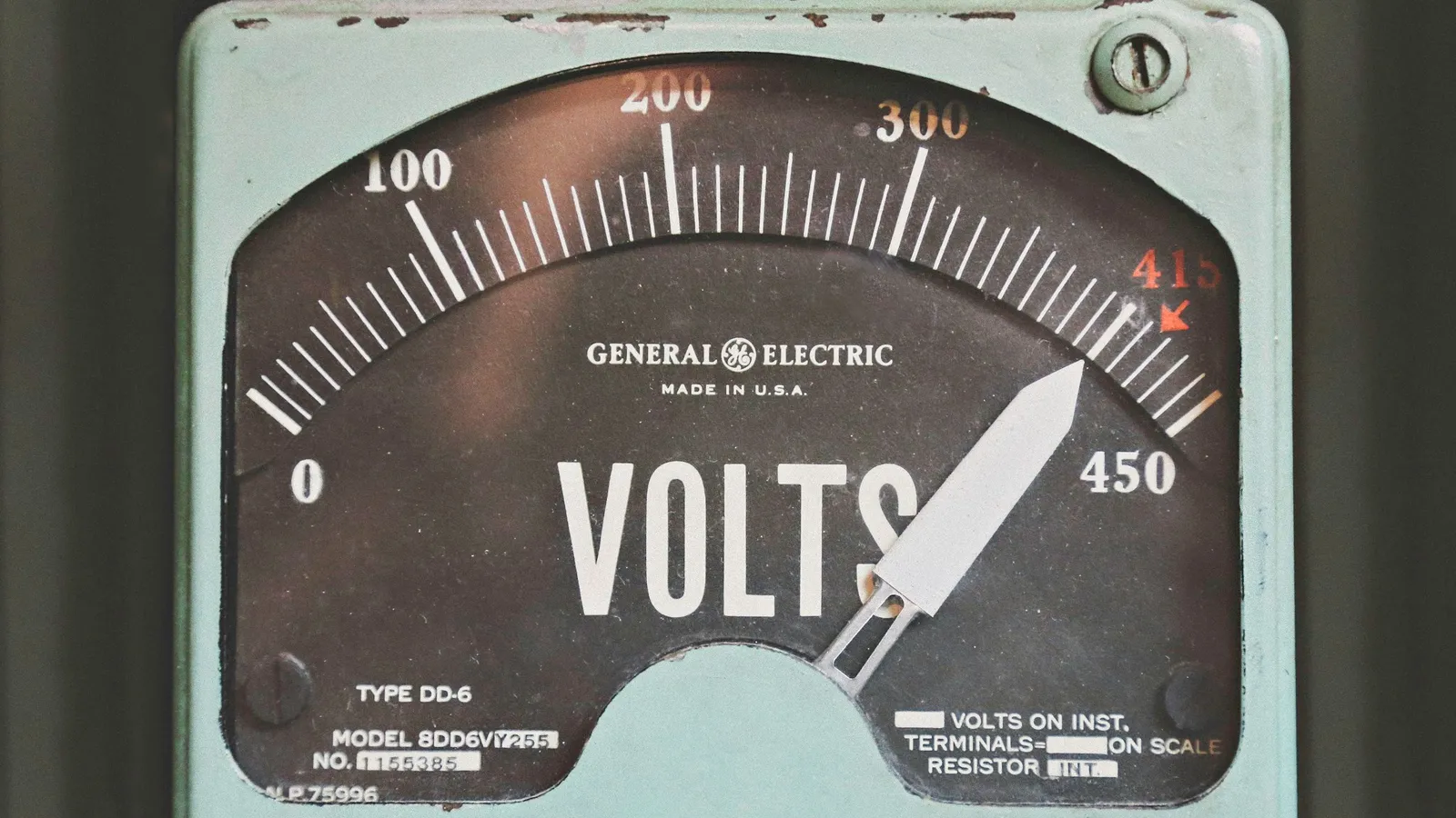 An analogue voltmeter with its needle on a printed scale
