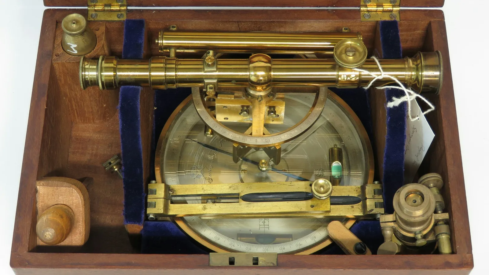 An antique brass scientific instrument in a wooden case