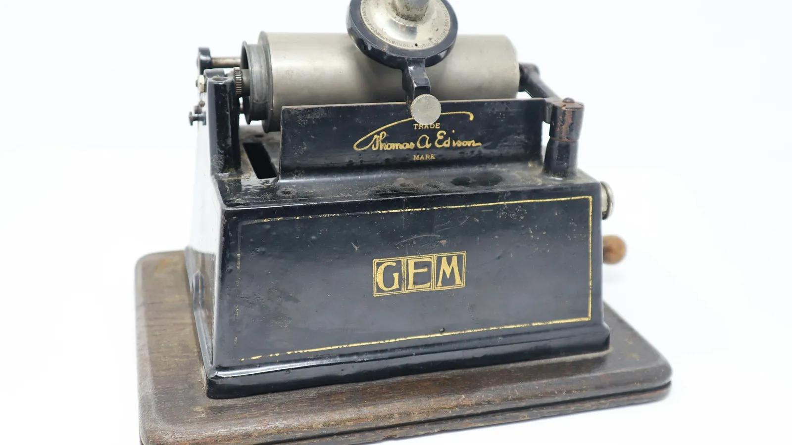 An antique cylinder phonograph on a white background