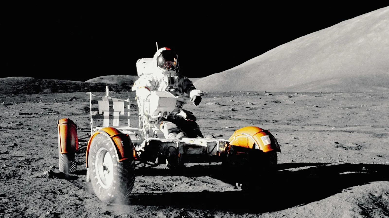 An astronaut beside a lunar rover on the Moon