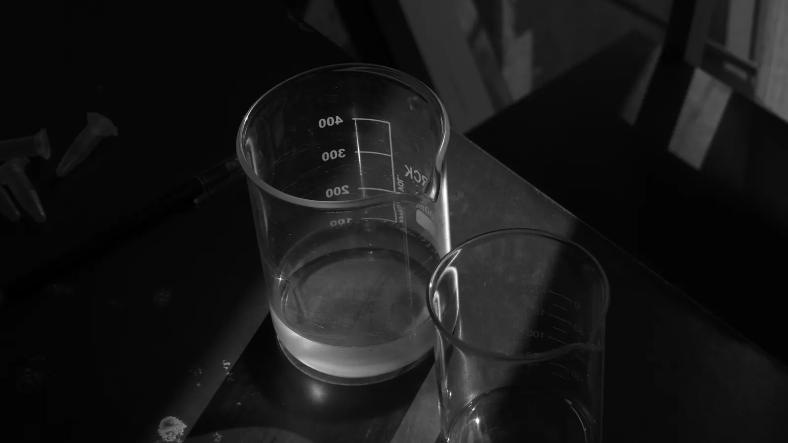 An empty glass beaker in black and white