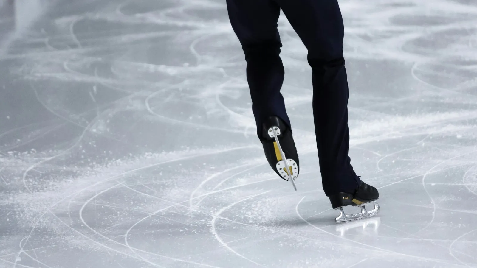 An ice skater gliding across the rink