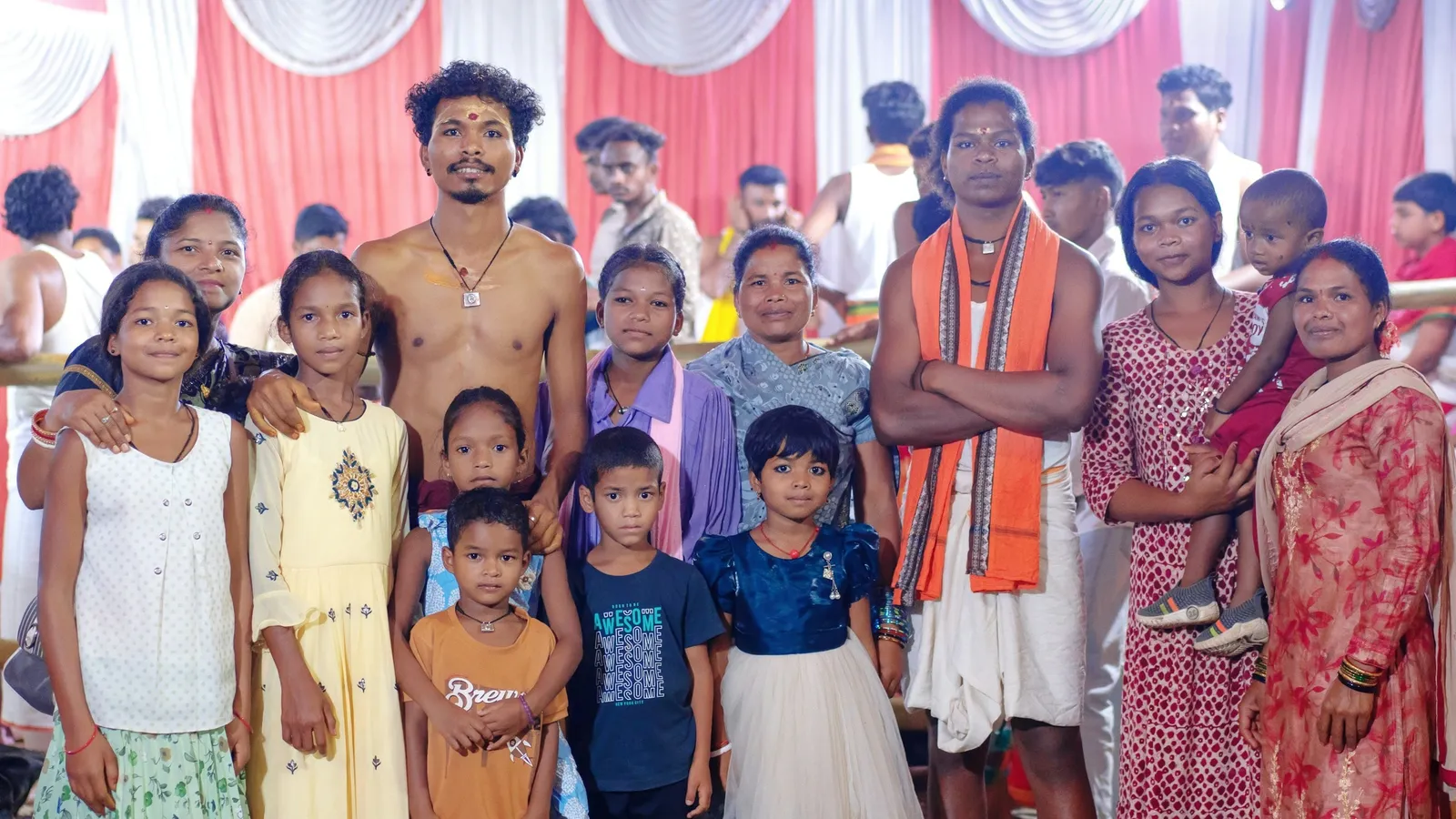 An Indian family of adults and children gathered indoors