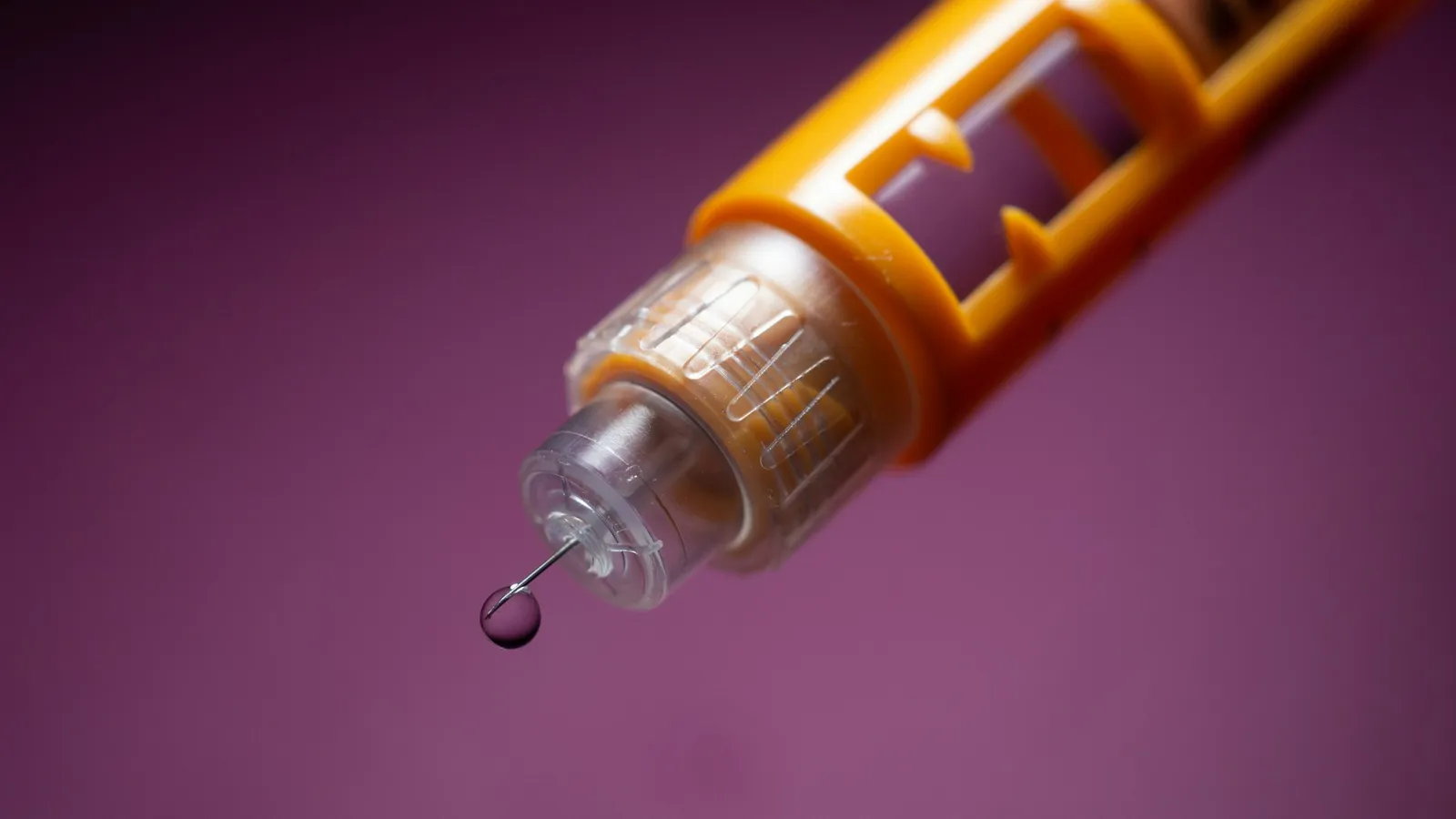 An insulin pen with a drop at its needle tip