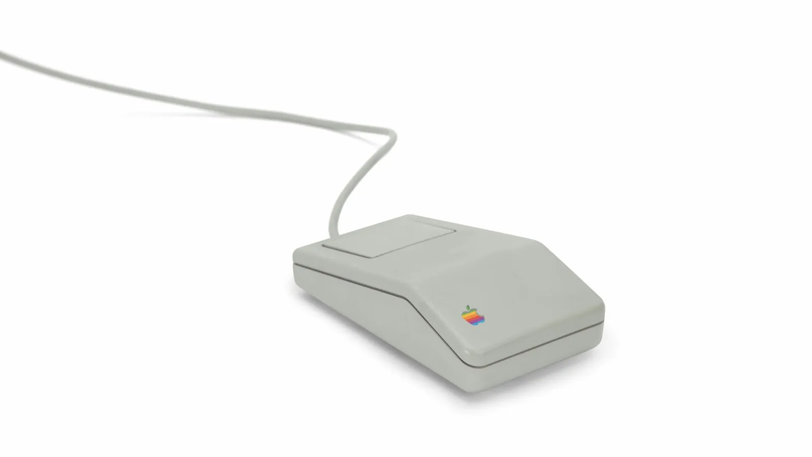 An old beige computer mouse with its cable