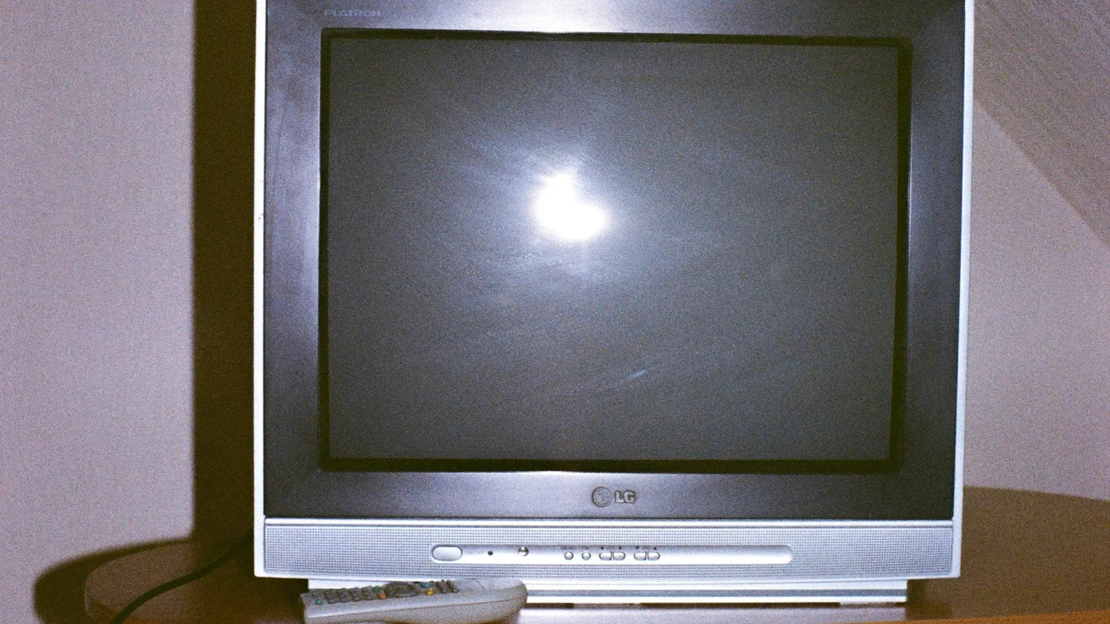 An old cathode-ray television set with a glowing screen