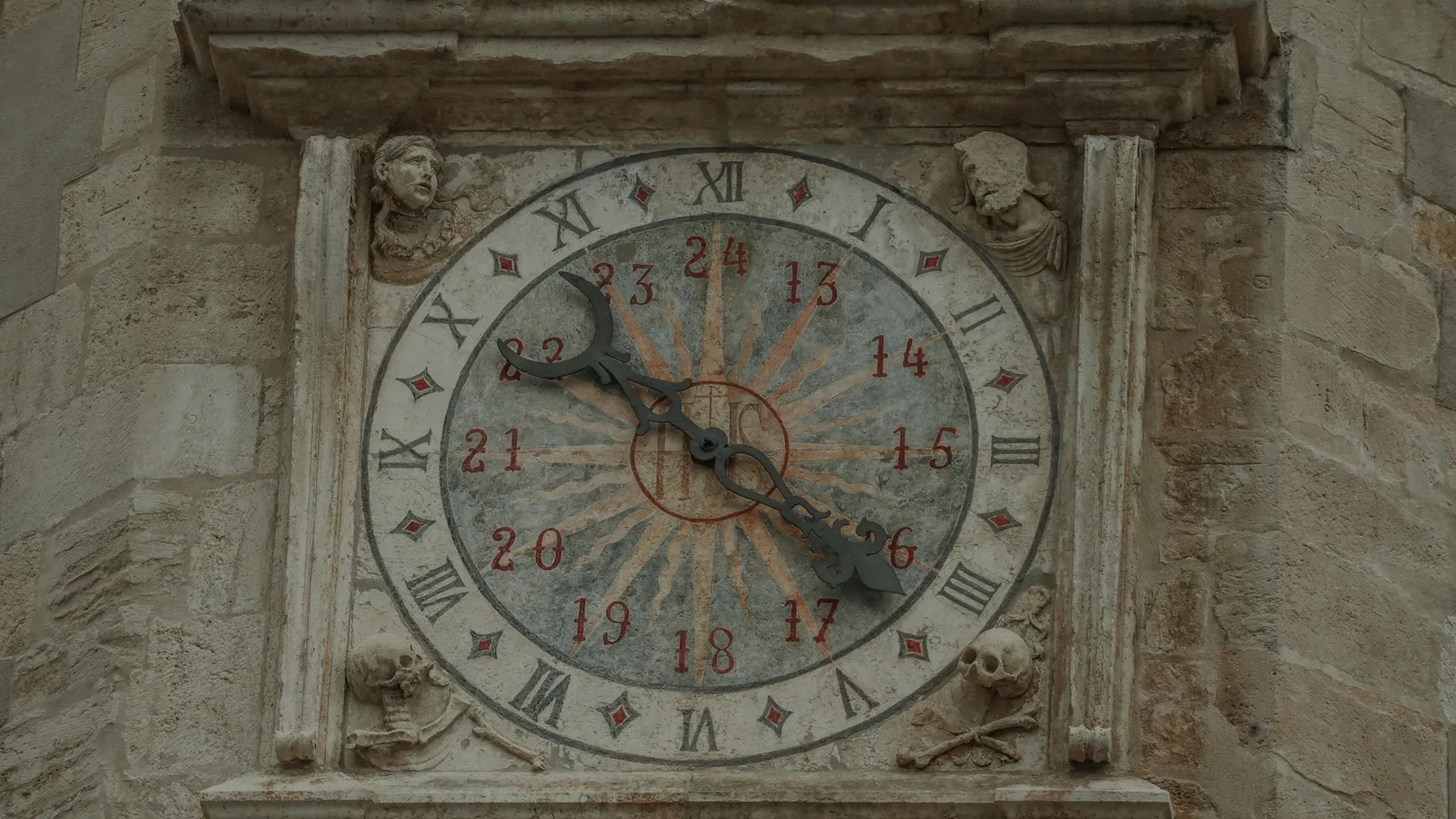 An old clock face set into a stone wall