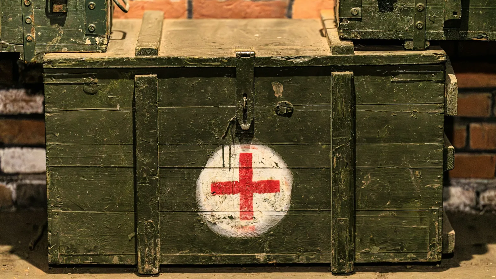 An old green army medical box marked with a red cross