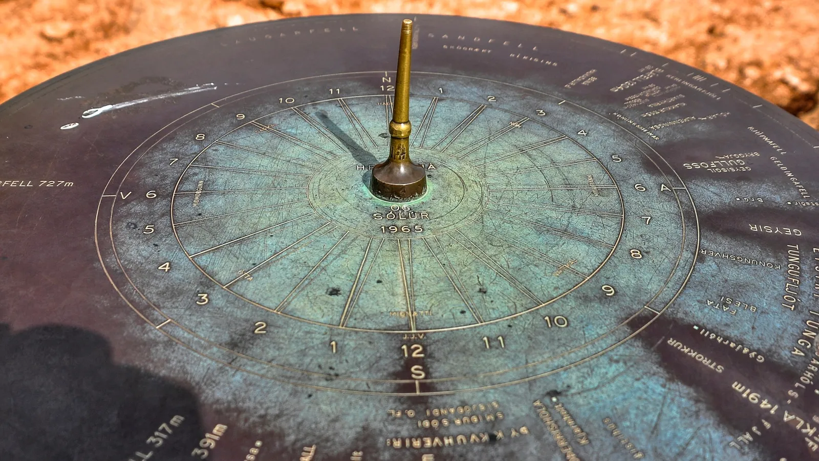 An old metal sundial with markings around its edge