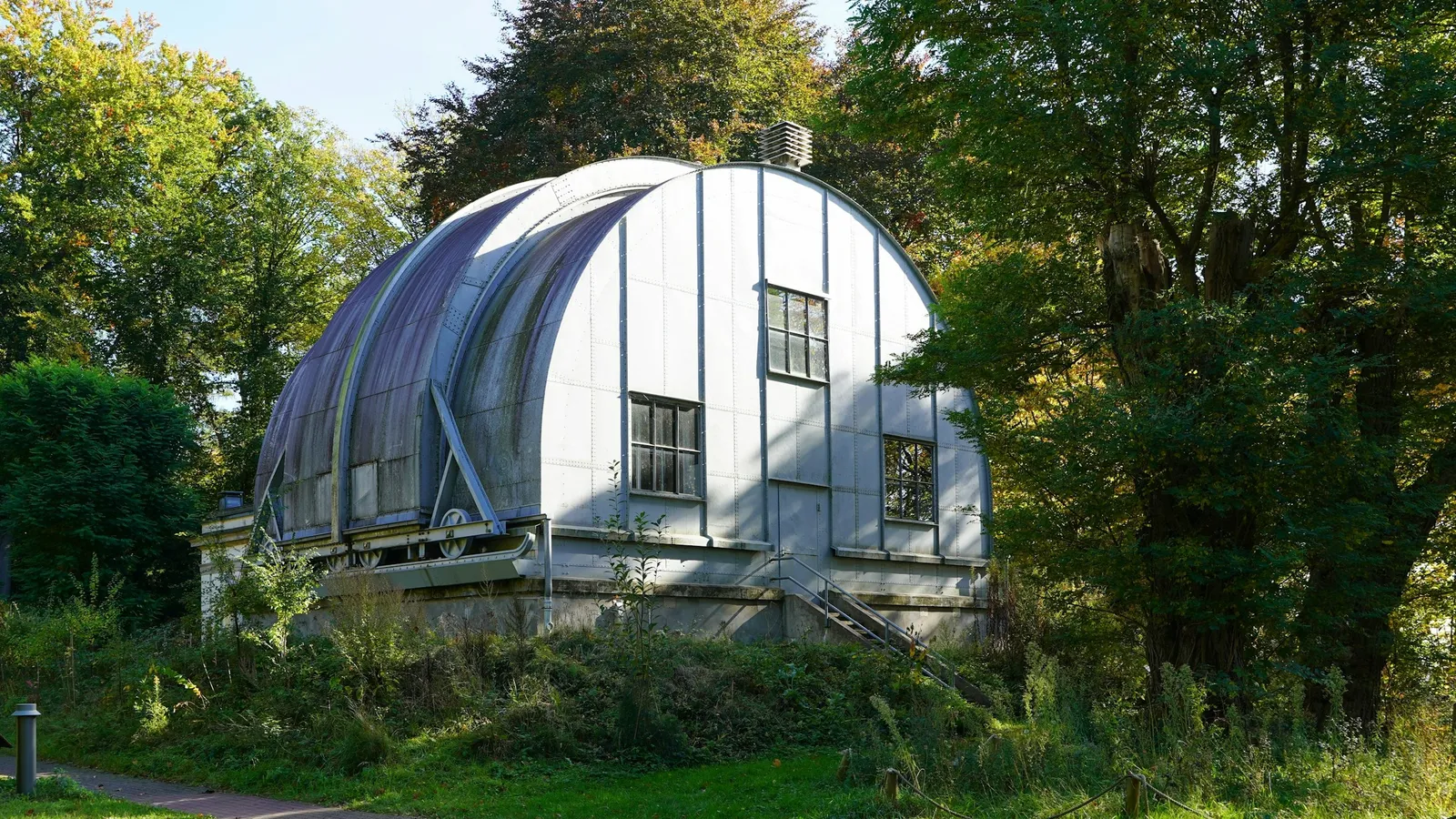 An old observatory dome among trees