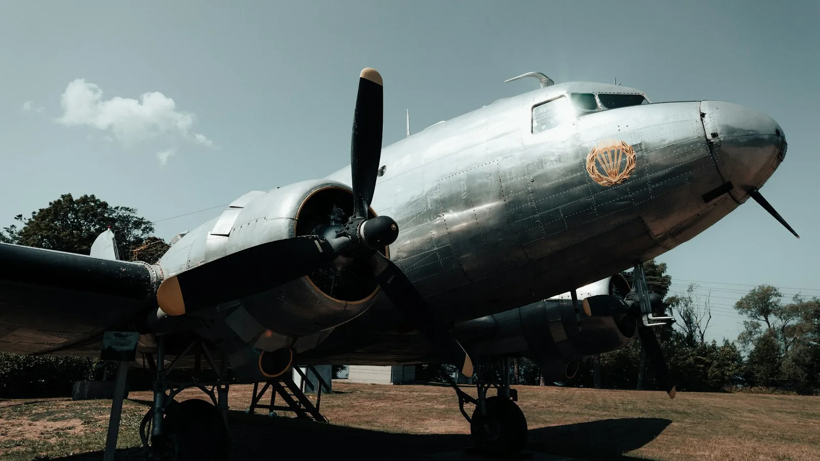 An old propeller aircraft parked on the ground