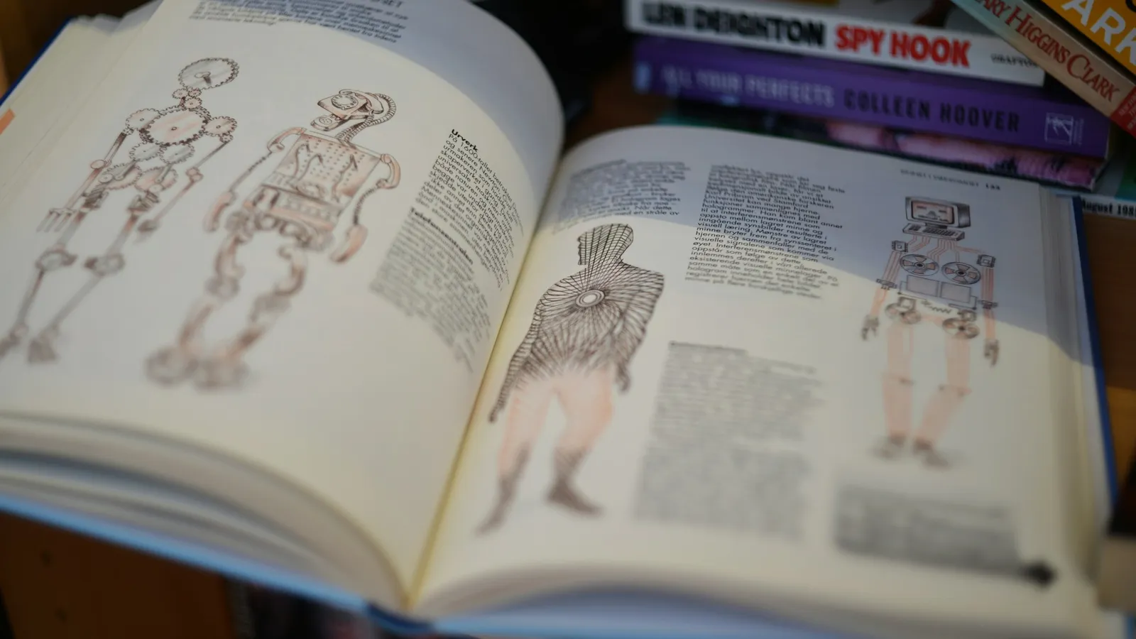 An open anatomy textbook showing illustrated diagrams of the human body