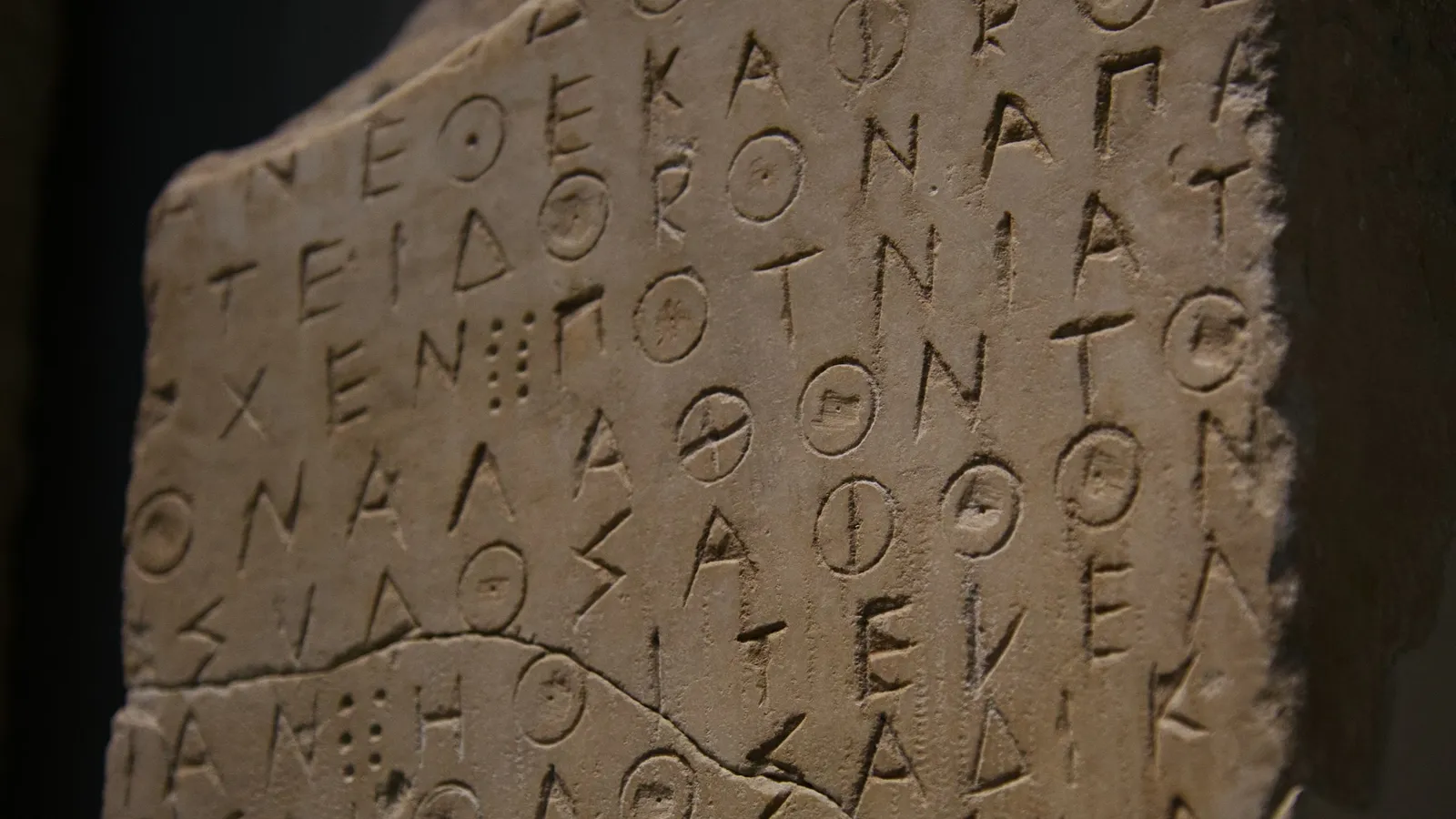 Ancient Greek letters carved into a stone slab