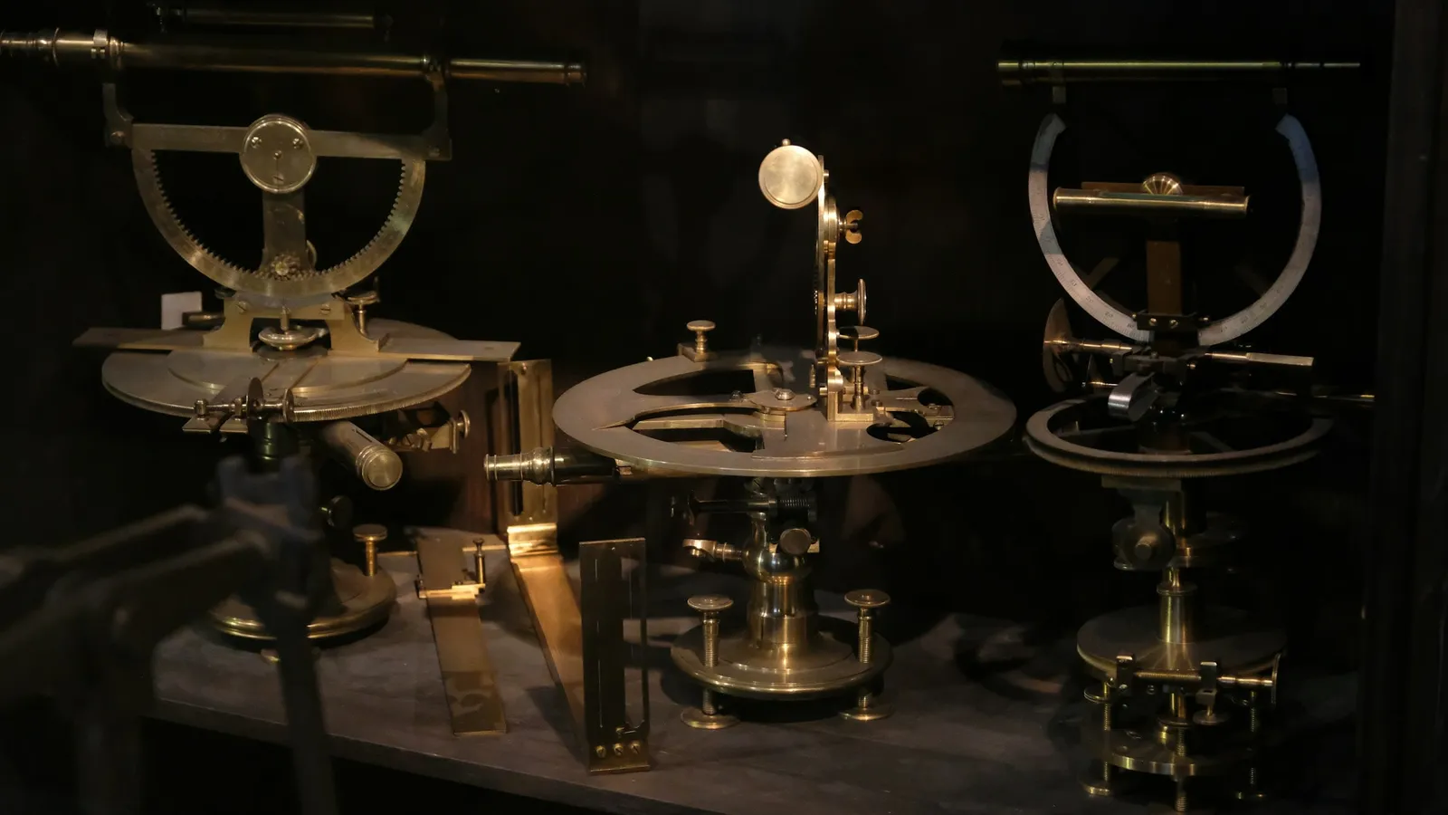 Antique brass scientific instruments in a dark display case