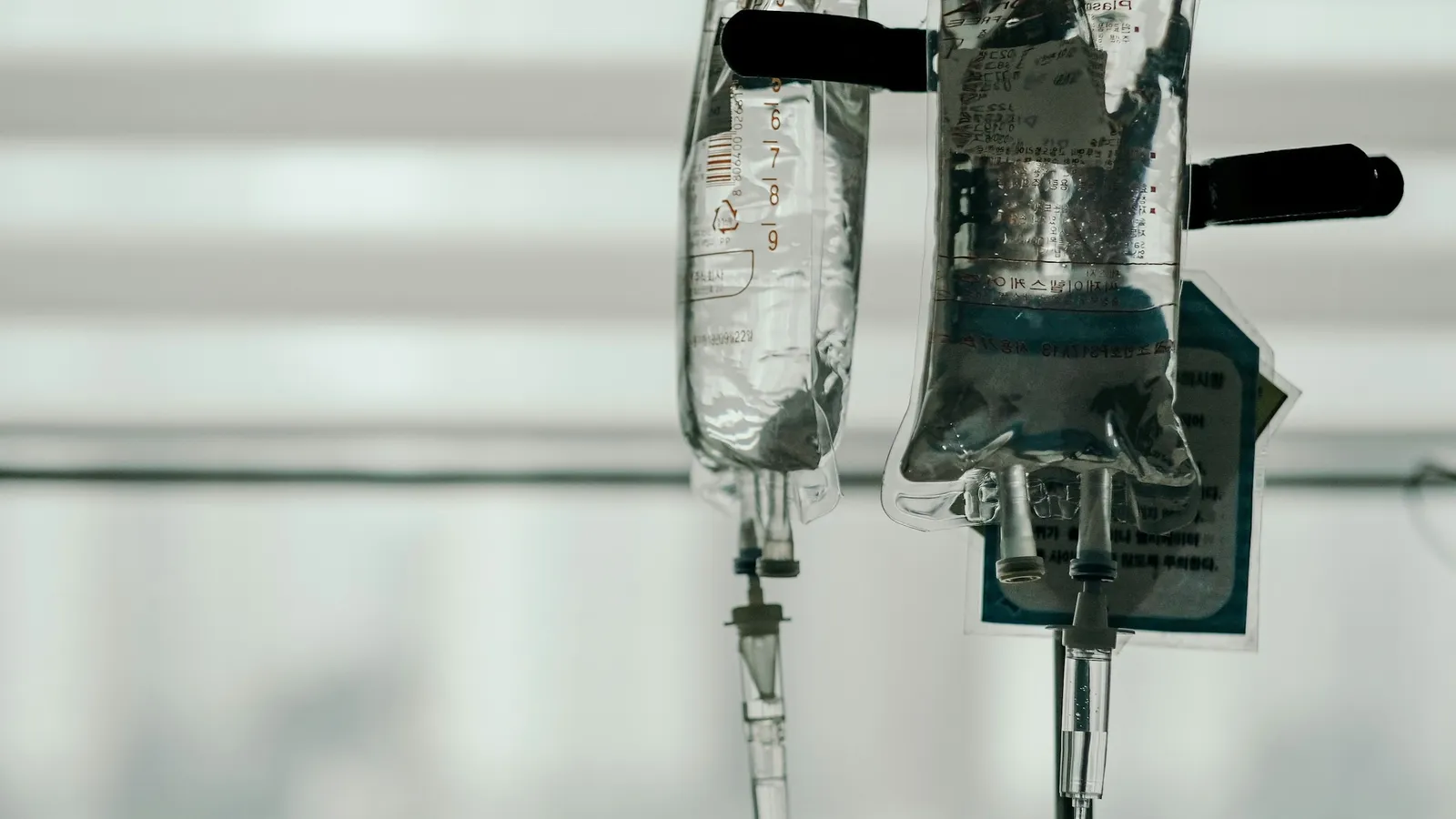 Bags of saline hanging on an intravenous drip stand