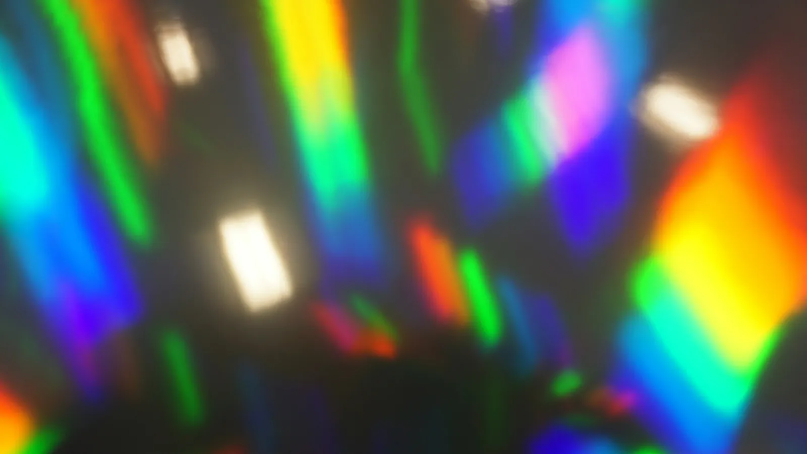 Bands of rainbow-coloured light falling on a surface