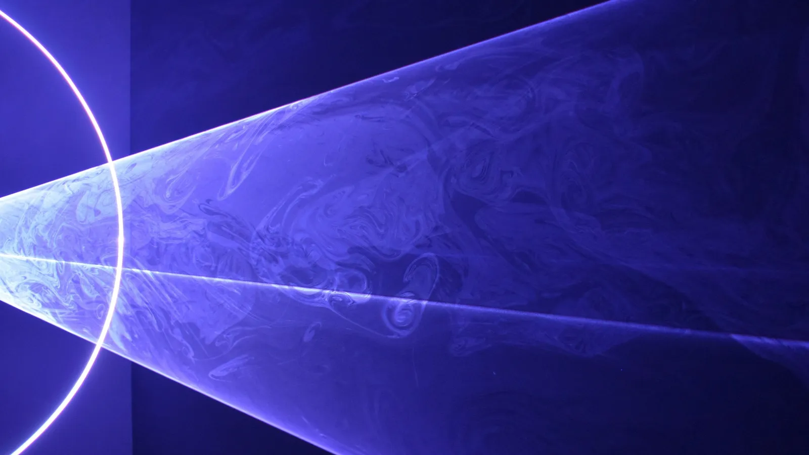 Beams of blue light fanning out in the dark