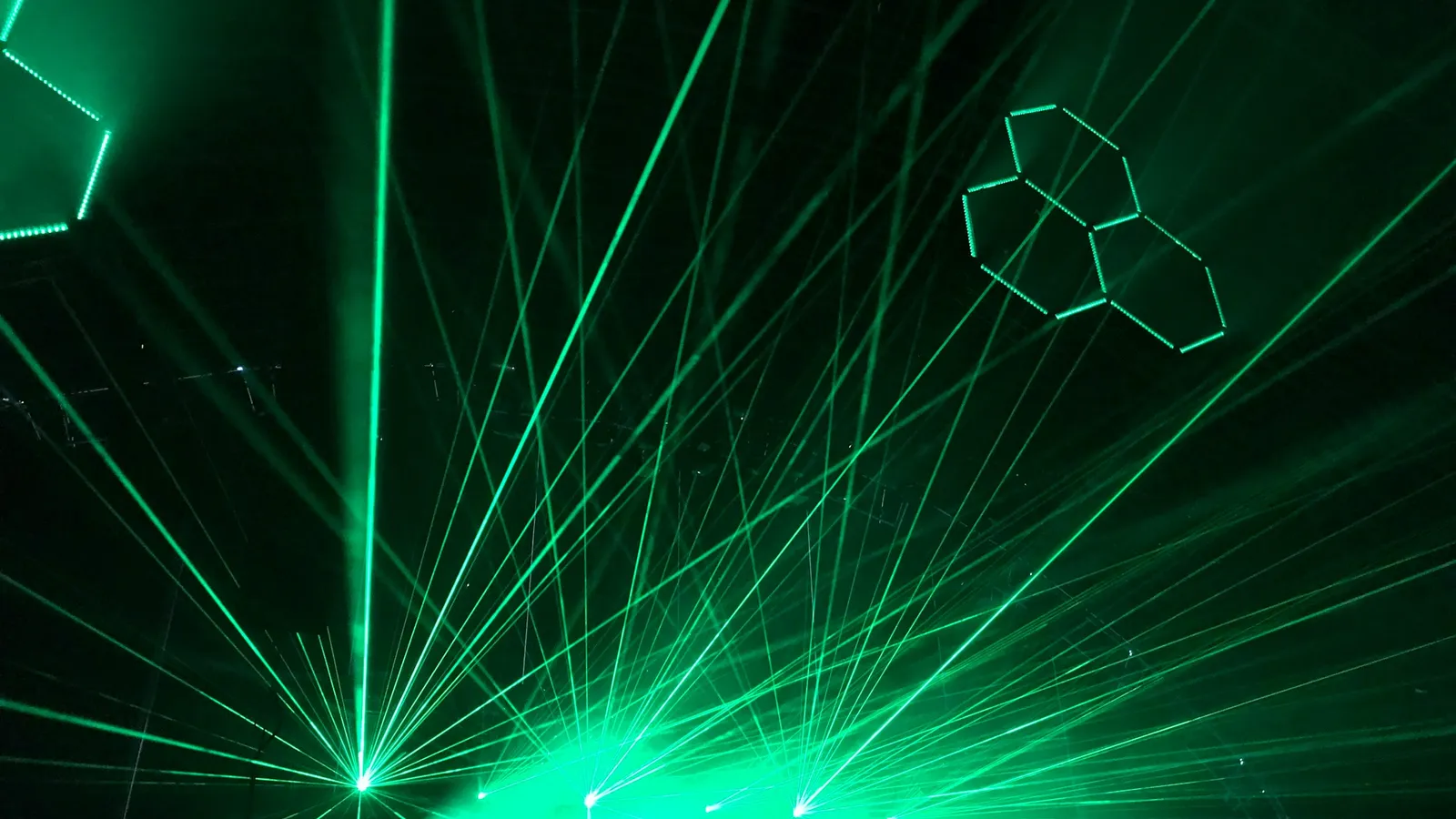 Beams of green light scattering through haze