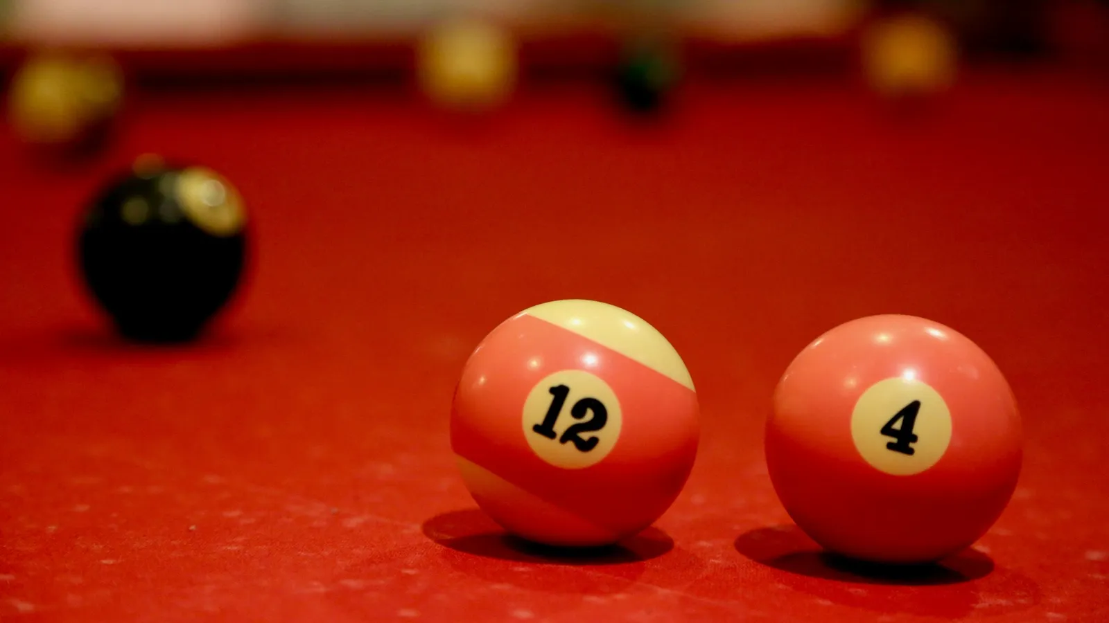 Billiard balls on a red pool table