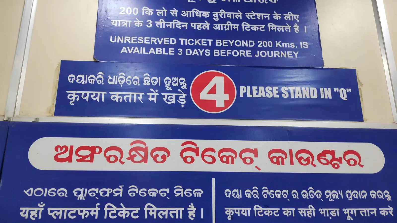Blue ticket counter signs at Bhubaneswar railway station in Odia, Hindi and English
