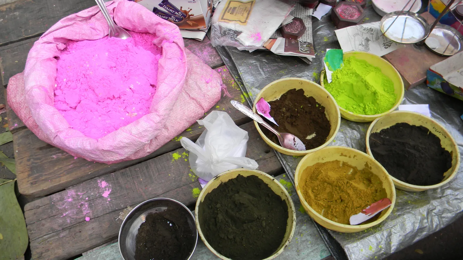 Bowls of vibrant Holi colour powders at a street shop