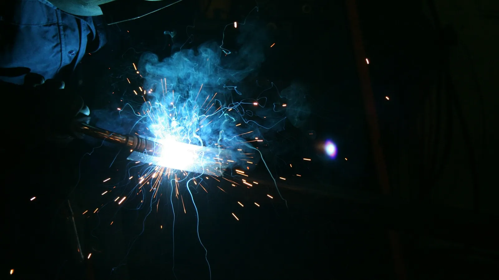 Bright sparks from a welding torch in the dark
