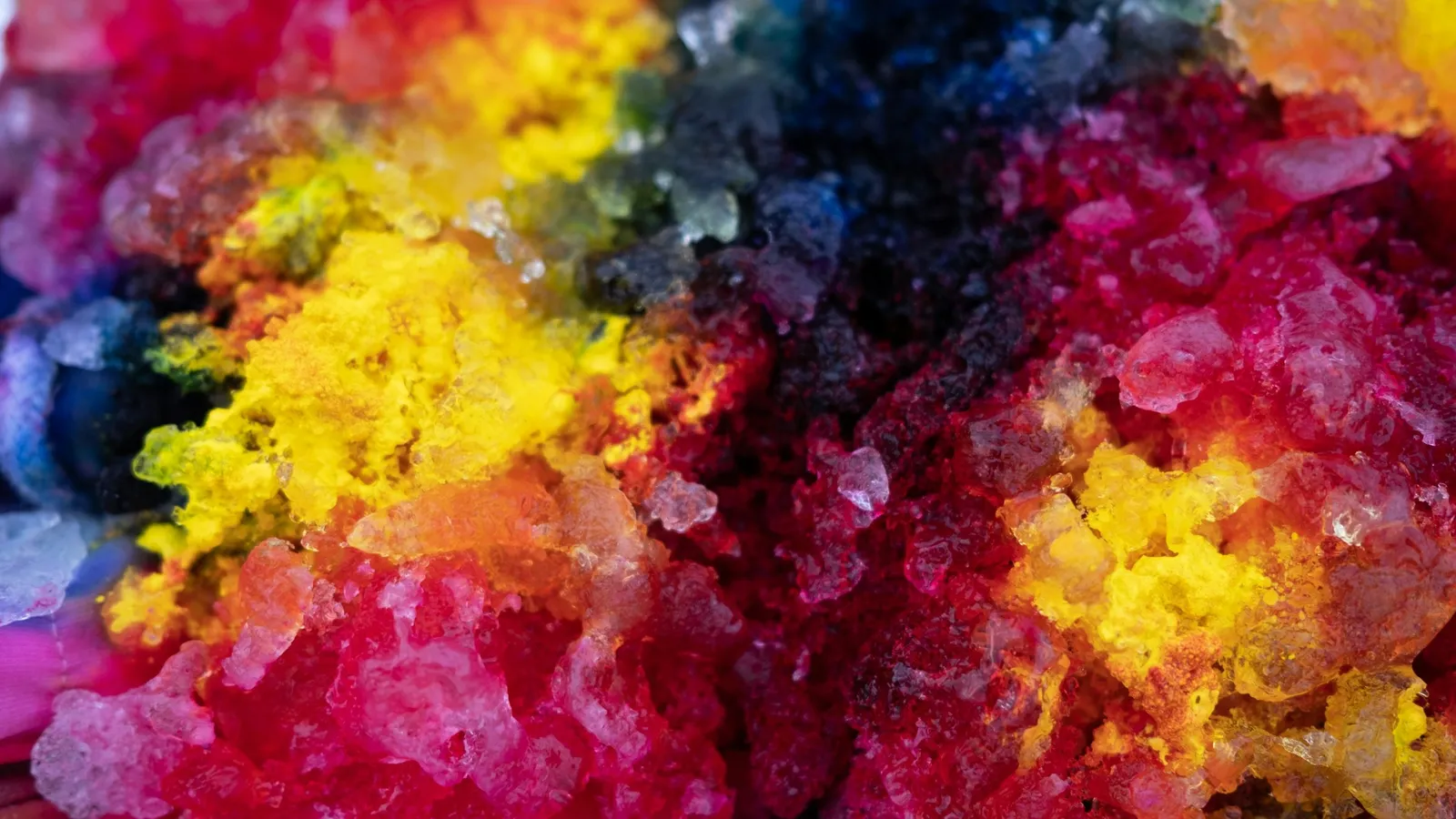 Brightly coloured crystals of different salts clustered together