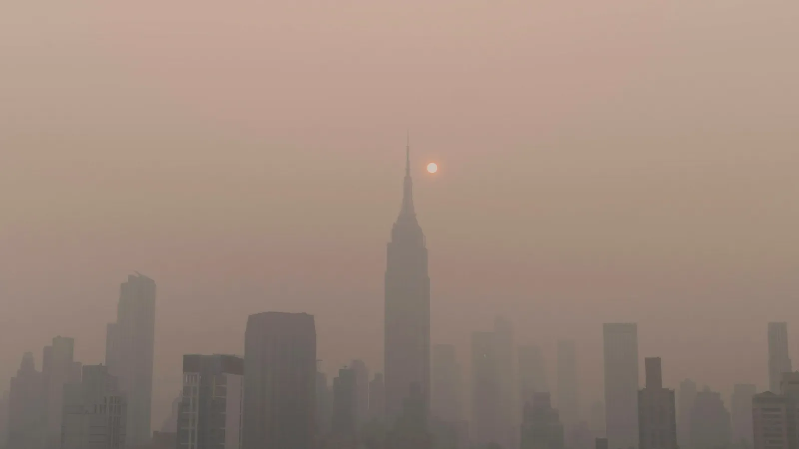 Brown smog hanging over a city skyline