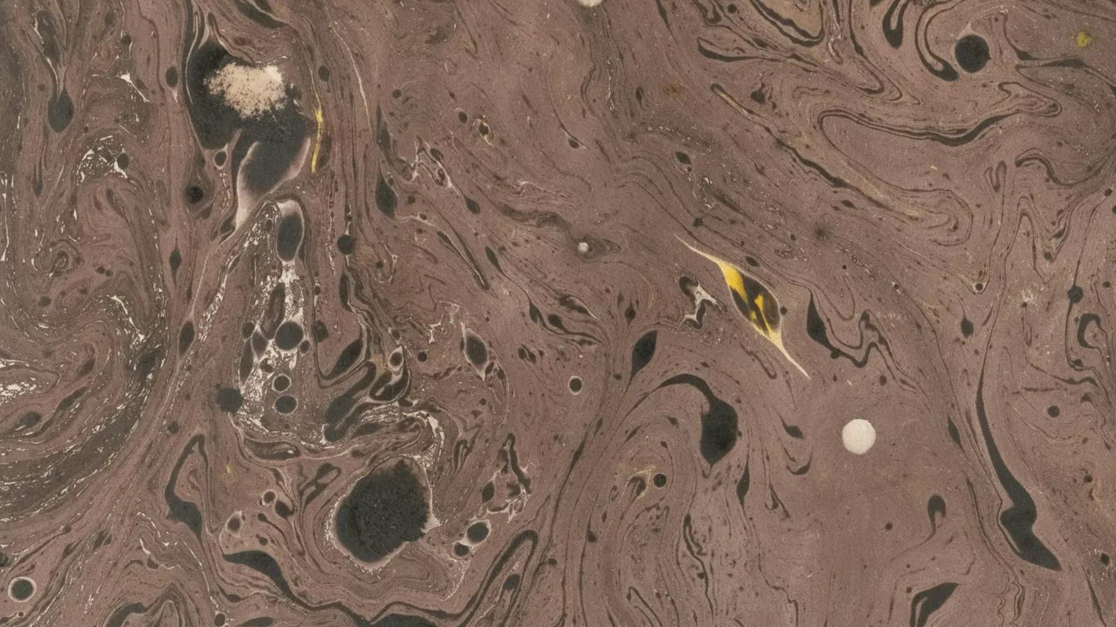 Brown swirls spreading through a liquid