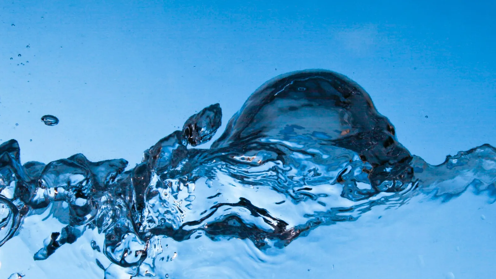 Bubbles rising through clear blue water