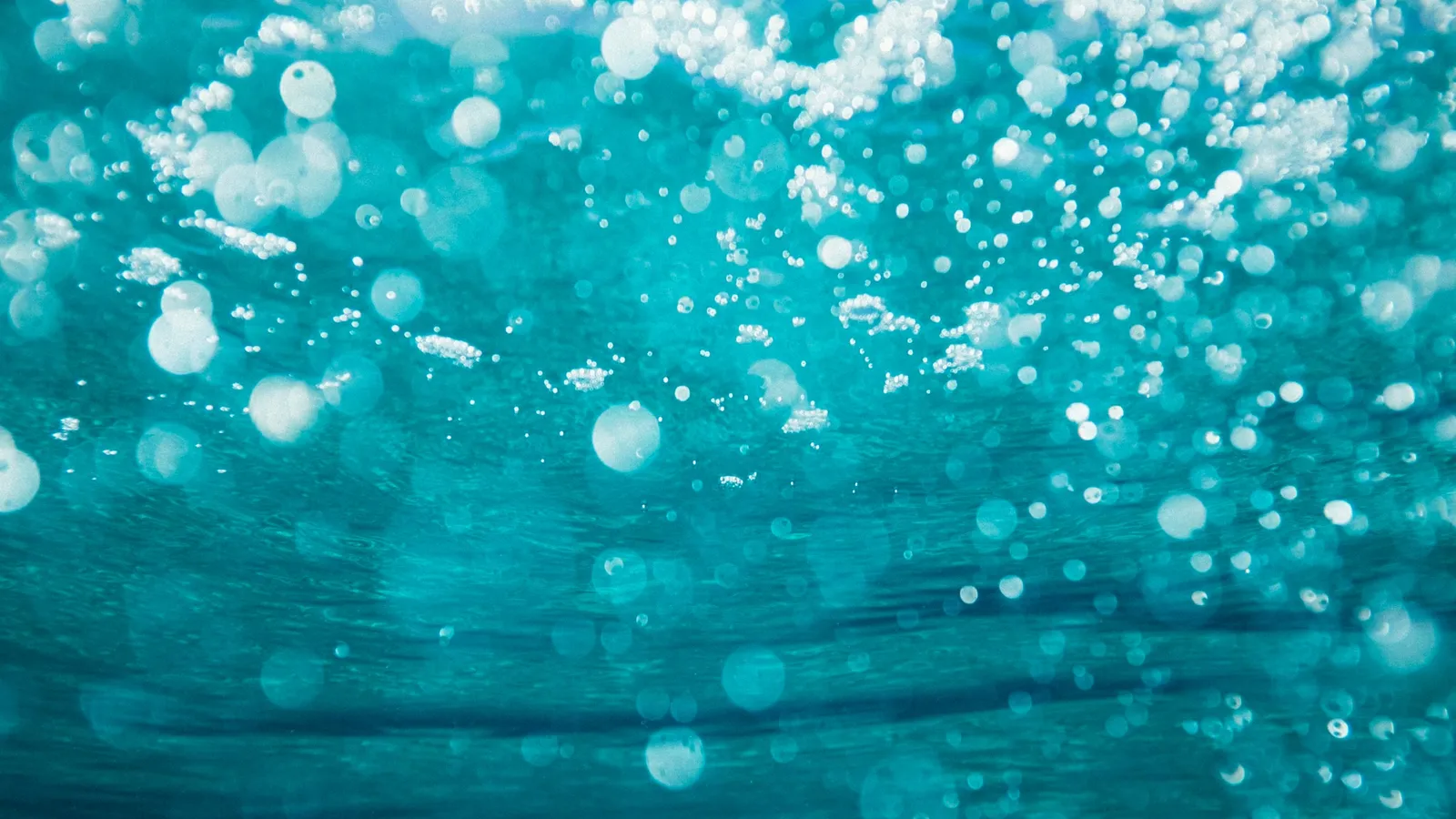 Bubbles rising through turquoise water