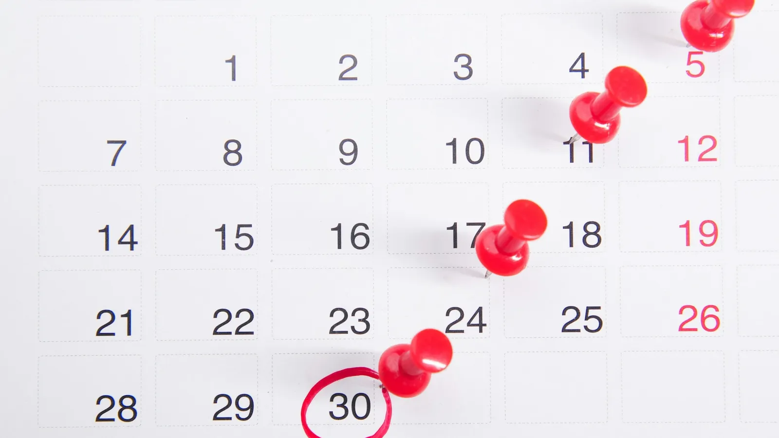 Calendar with dates marked by red pins