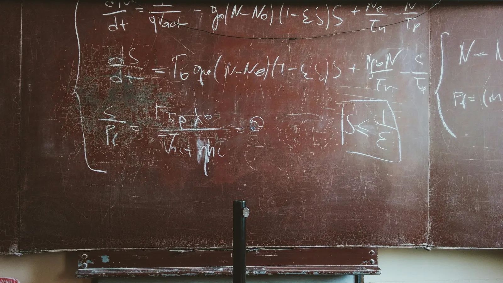 Chalkboard covered in handwritten equations