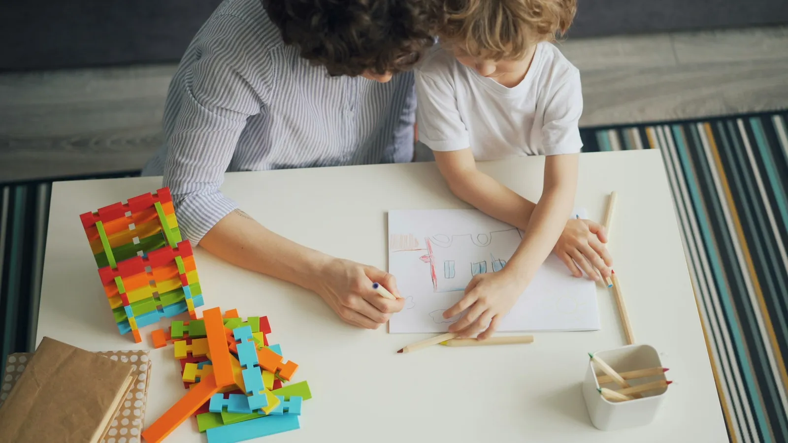 Child and adult working on sums with a counting toy