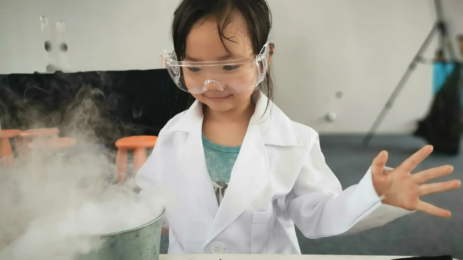 Child in a lab coat doing a science experiment