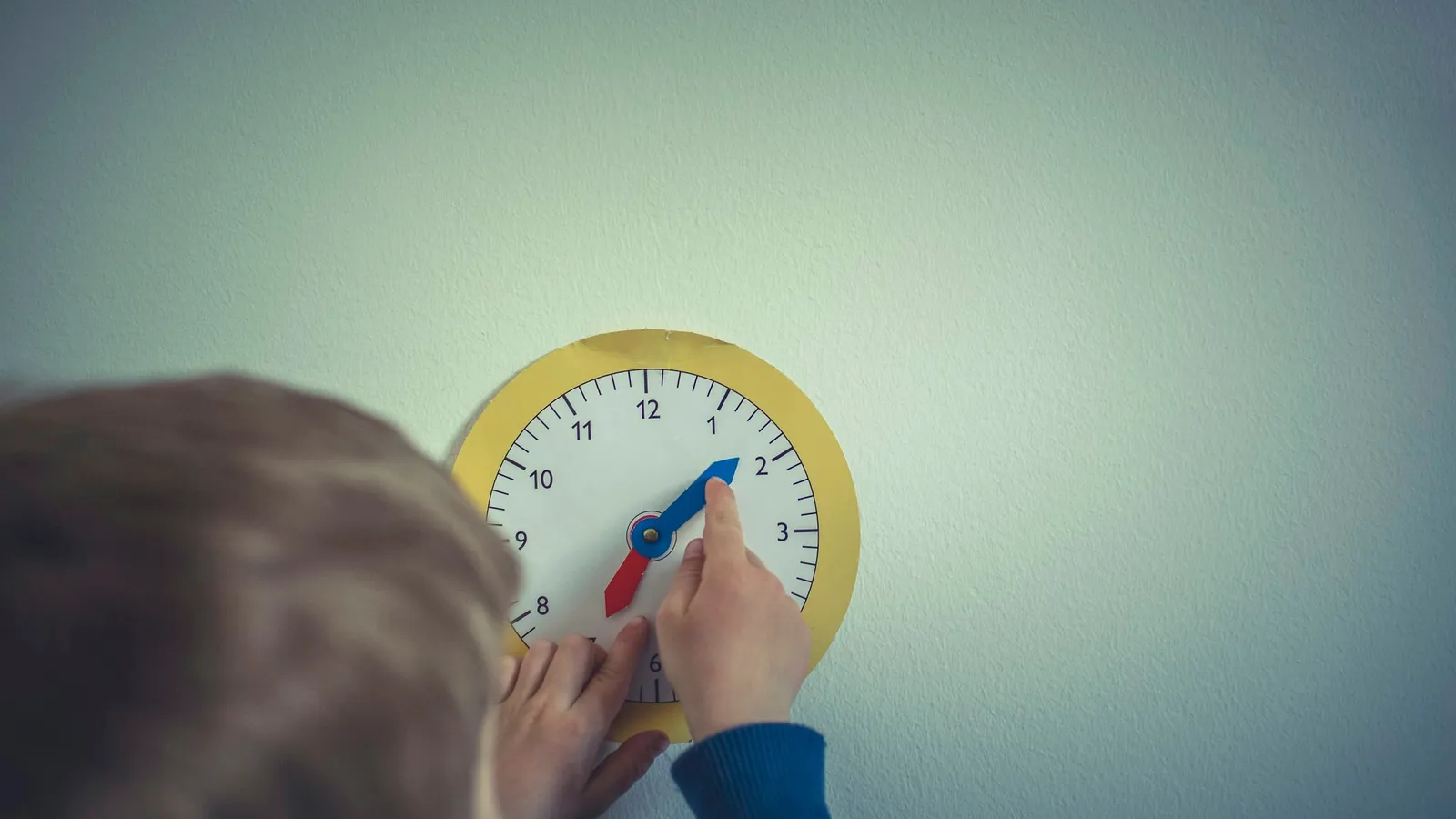 Child looking at a clock