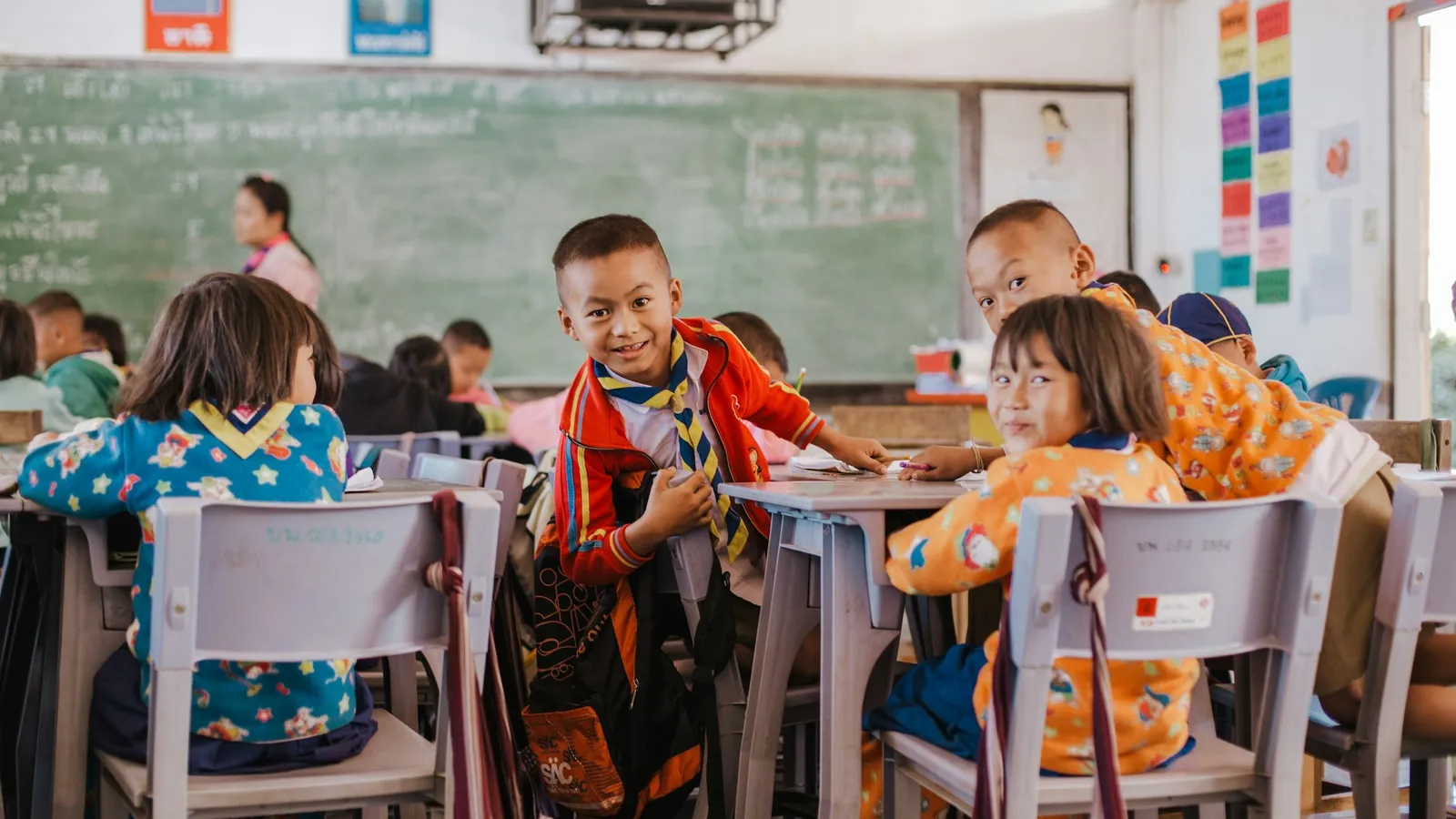 Children working in small groups at classroom tables