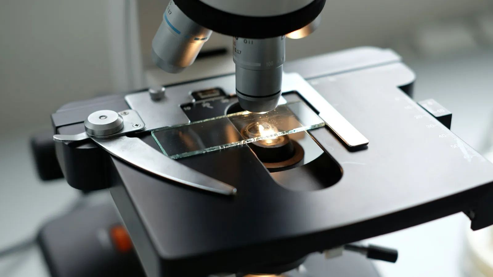 Close-up of a microscope stage and objective lenses