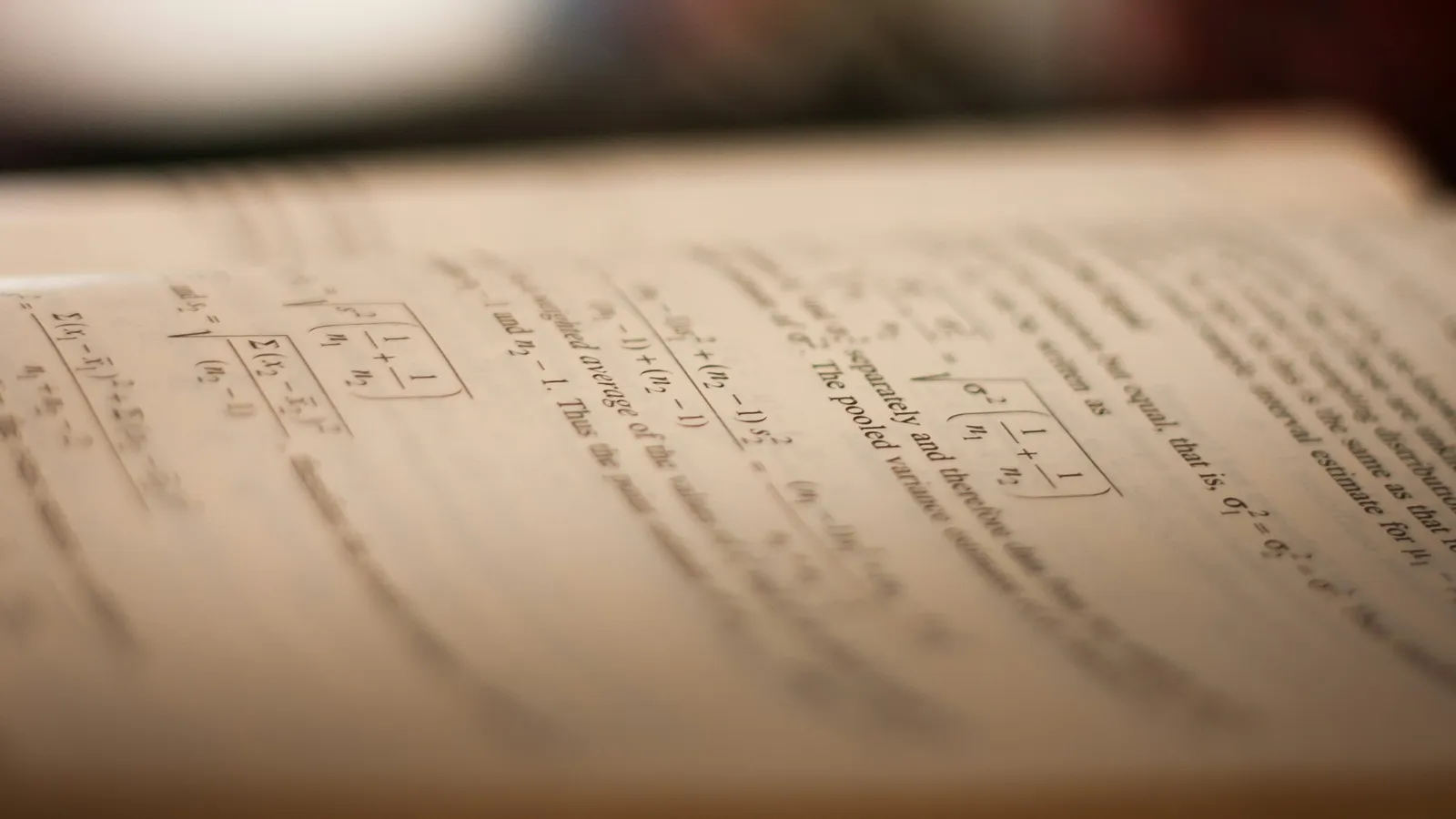 Close-up of an open textbook page in warm light