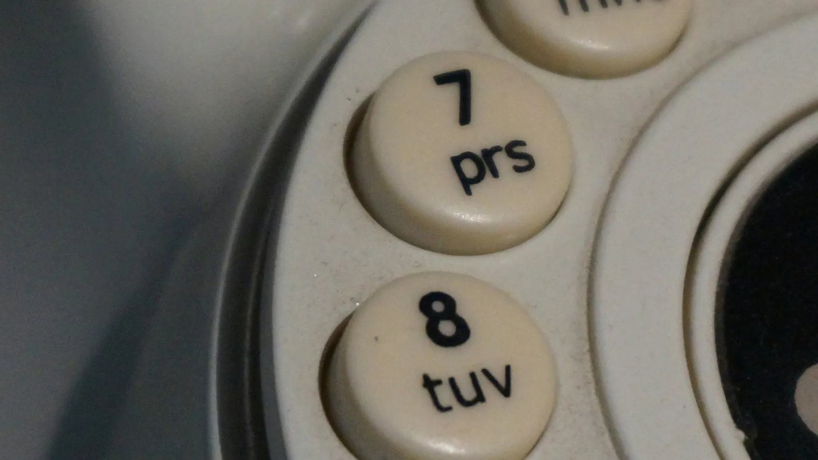Close-up of the numbered dial of an old telephone