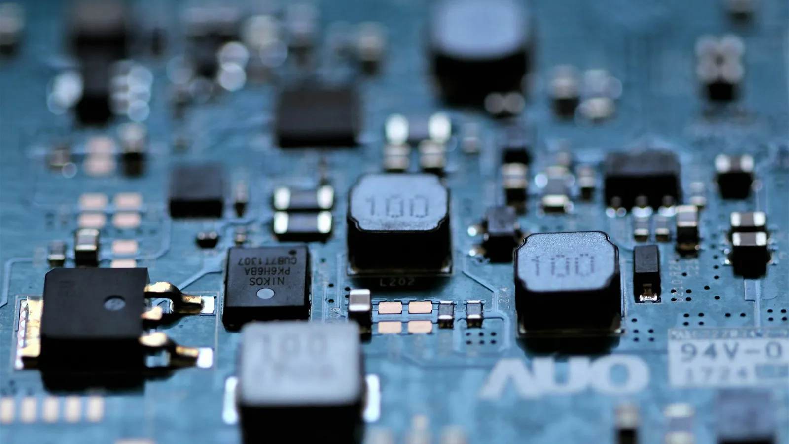 Close-up of tiny components on a blue circuit board